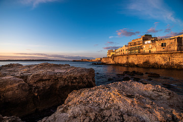 sunset on beach ad rocks