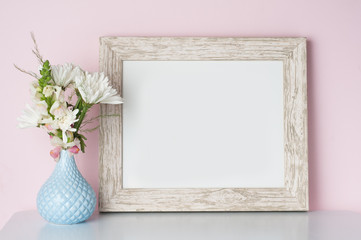 frame mockup with a pink background and flowers