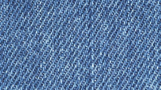 Jeans fabric plain surface background. Denim textile texture tracking. Top view. Slider shot