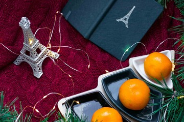 tangerines, Christmas tree on a red background. Eiffel tower, Paris, plans for the New year and Christmas.