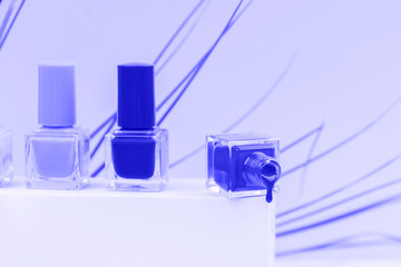 Nail polishes in classic blue color. Trendy mood. Beauty concept.