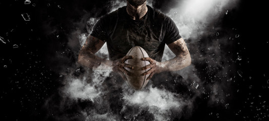 Rugby player in action on dark - 309455556