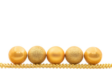 A minimalist design of a horizontal, symmetrical line of gold Christmas baubles and beads isolated against a white background