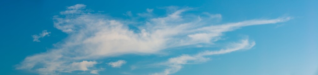 Fantastic clouds against blue sky, panorama