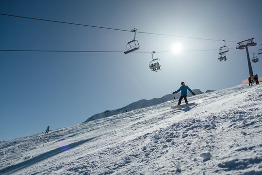 Woman riding a snowboard a on a steep slope