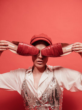 Fashionable trendy crossdresser on red background