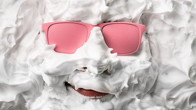 Portrait of a man with shaving foam and pink glasses