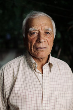 Portrait of elderly man looking at camera