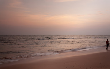 Naklejka na ściany i meble Susnet at Anjuna beach goa with a man on the beach