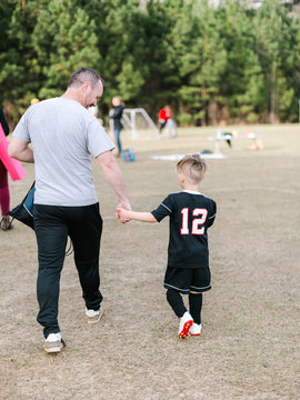 Father And Son Going To Soccer Practice