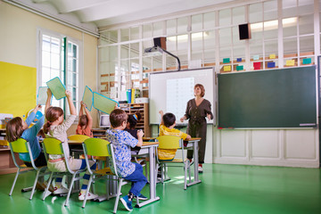 Young pupils and their teacher during a math class