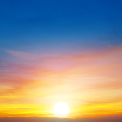 Fototapeta na wymiar Cloudy sky and bright sunrise over the horizon.
