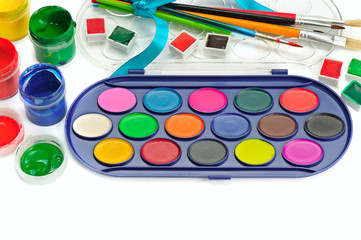 Watercolor paints, gouaches and brushes isolated on white background.