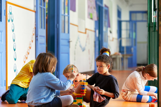 Schoolmates playing with blocks