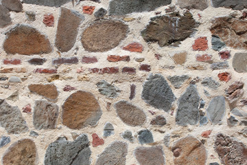 Rough weathered sandstone wall surface texture close up