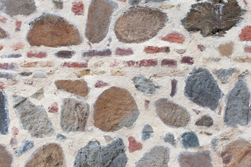 Rough weathered sandstone wall surface texture close up