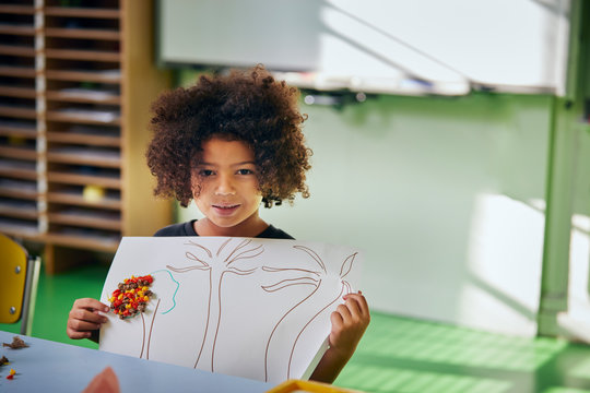 Schoolgirl showing her art work