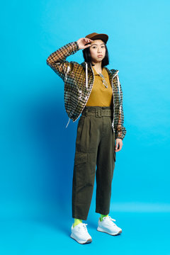 Young serious stylish lady in cap