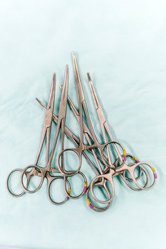 Surgical scissors on green gown