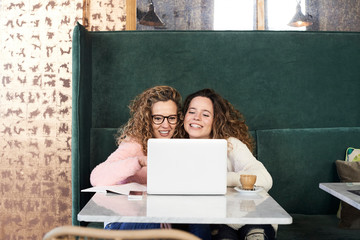 Mother and daughter using laptop.