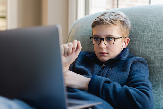 preteen watching a video on his computer