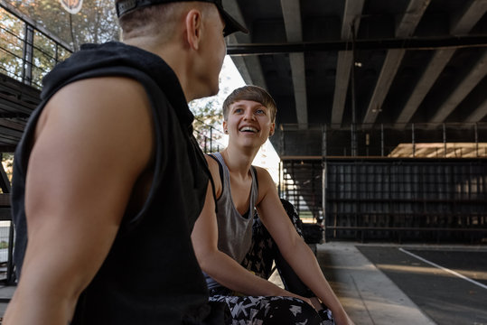 Chatting sportive couple on bench