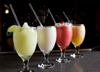Four sweet mixed drinks at a local bar