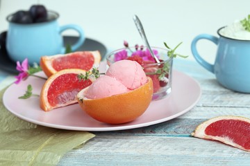 Natural ice cream, grapefruit, basil on a wooden table, tasty and healthy dessert, seasonal food