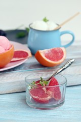 Natural ice cream, grapefruit, basil on a wooden table, tasty and healthy dessert, seasonal food