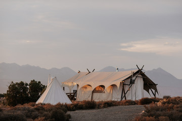 Canvas glamping tents at sunrise in the desert