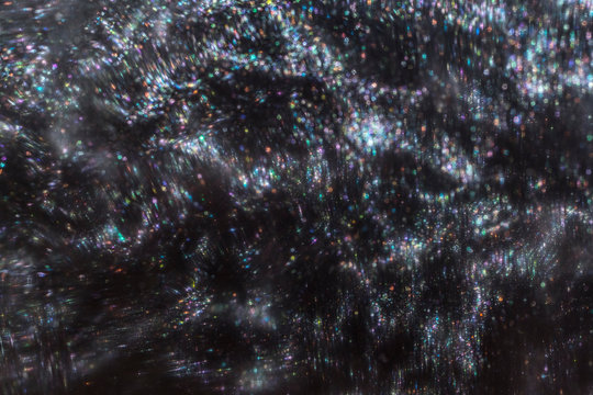 Colorful holographic silver liquid close up