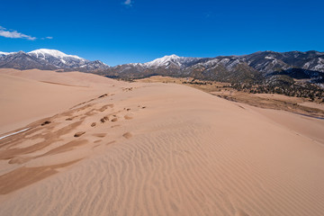 Sand Dunes Amidst the Snowy Mountains