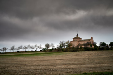 Hermitage of Santa Ana of the twelfth century and baroque style in winter cloudy day with the planted in front in Val de Santo Domingo, Toledo_Spain