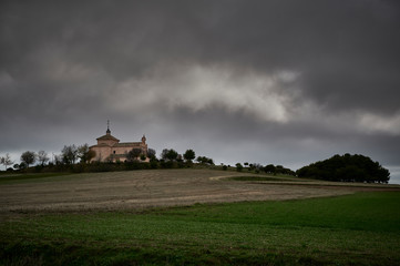 Obraz premium Hermitage of Santa Ana of the twelfth century and baroque style in winter cloudy day with the planted in front in Val de Santo Domingo, Toledo_Spain