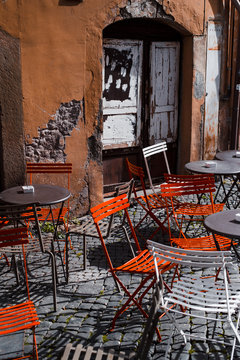 atmospheric street cafe - empty tables against grungy wall in Firenze, Italy