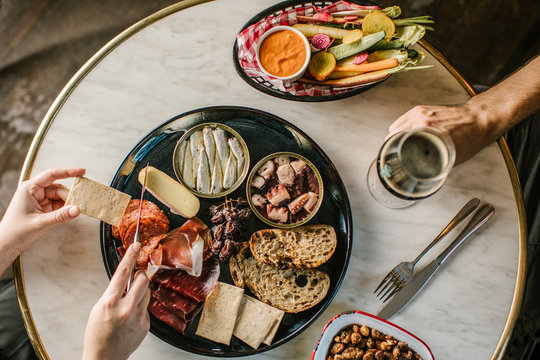 A man and woman sharing charcuterie