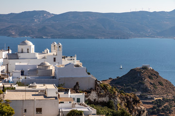 Church and houses  in Plaka village with bay in background