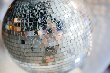 Large mirror disco ball with multi-colored reflections