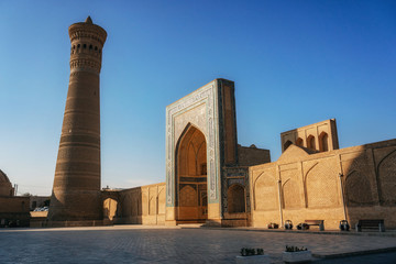 View islamic religious complex of Poi Kalan located around the Kalan minaret in Bukhara at sunrise,...