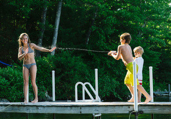 Boys Squirting Water Guns at Girl