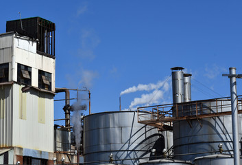 Open windows looking over a refinery