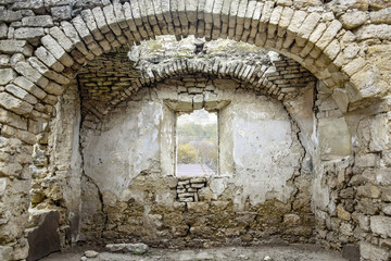 Ruins of an ancient Christian temple. Collapsed ceiling. Masonry, room with arched vaults. Window without a frame. Rashkov, Moldova. Close-up.