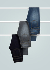 set of Men jeans hanging isolated on white background
