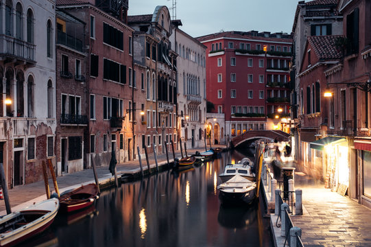 Colourful Venice Canal with evening lights and boats
