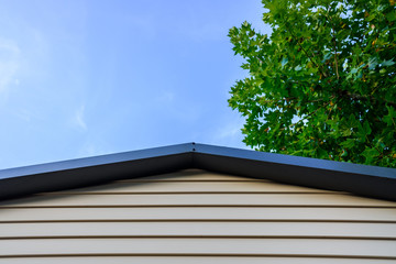 Roof and wooden wall of a cottage, space for text.