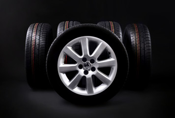 New tires on a dark background. Tyre fitting concept.