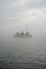 Fototapeta na wymiar ferry on a lake in fog