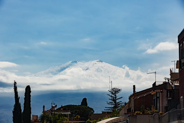 snow covered volcano Etna during abnormally cold spring, Taormina, Sicily