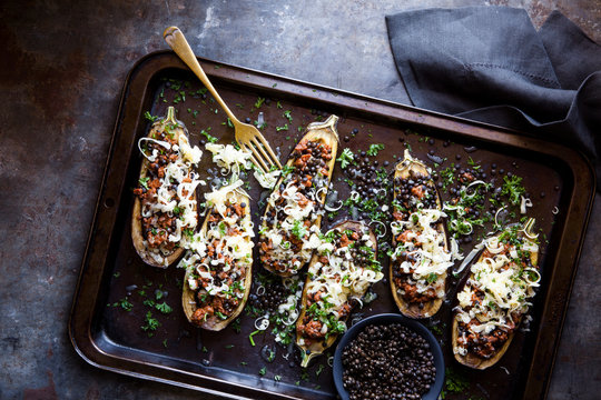 Spicy lamb stuffed aubergines with black lentils and cheese