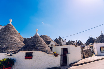 Houses of the tourist and famous Italian city of Alberobello, with its typical white walls and...